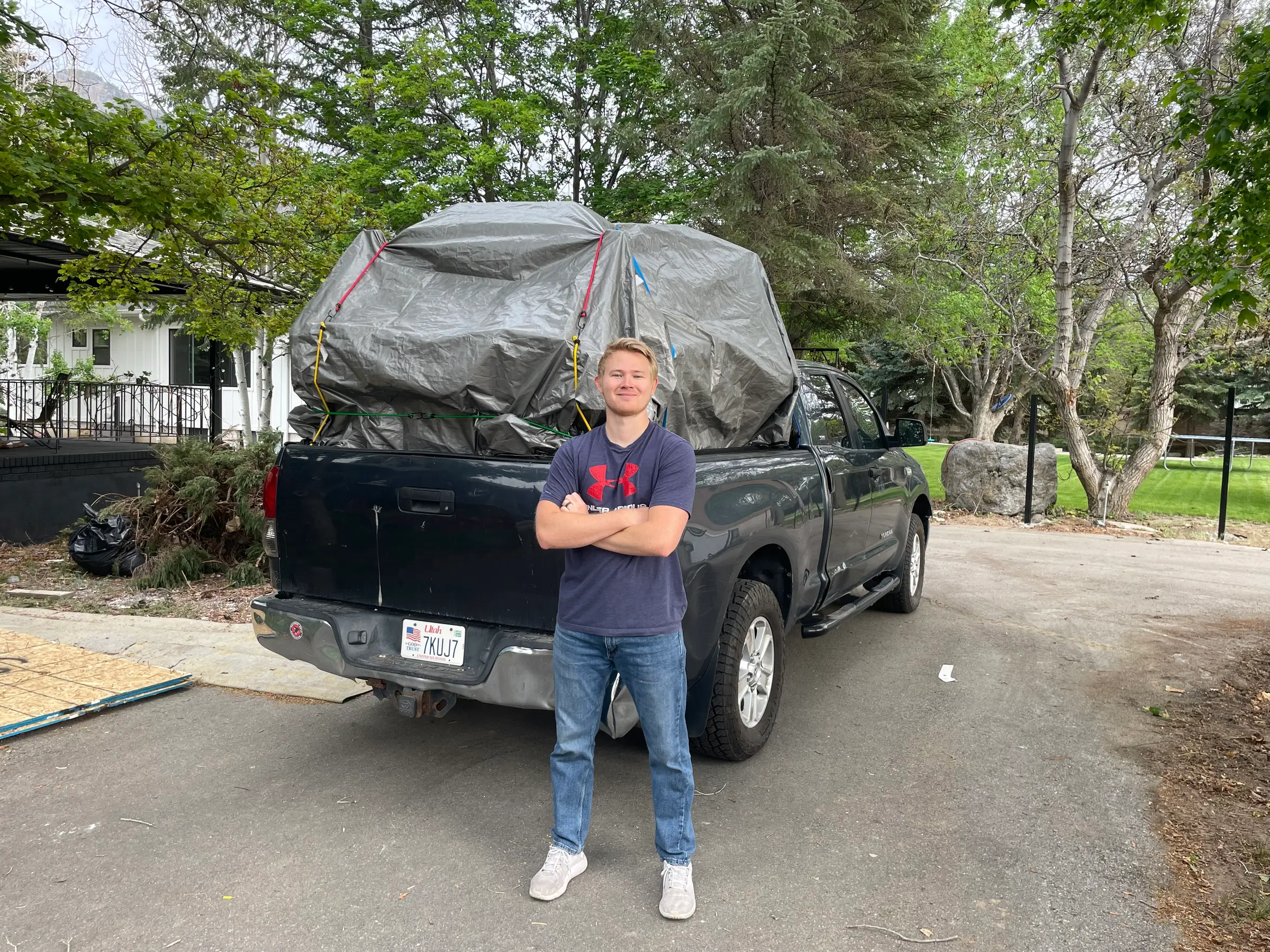 Utah County Hauling team member standing in front of loaded truck
