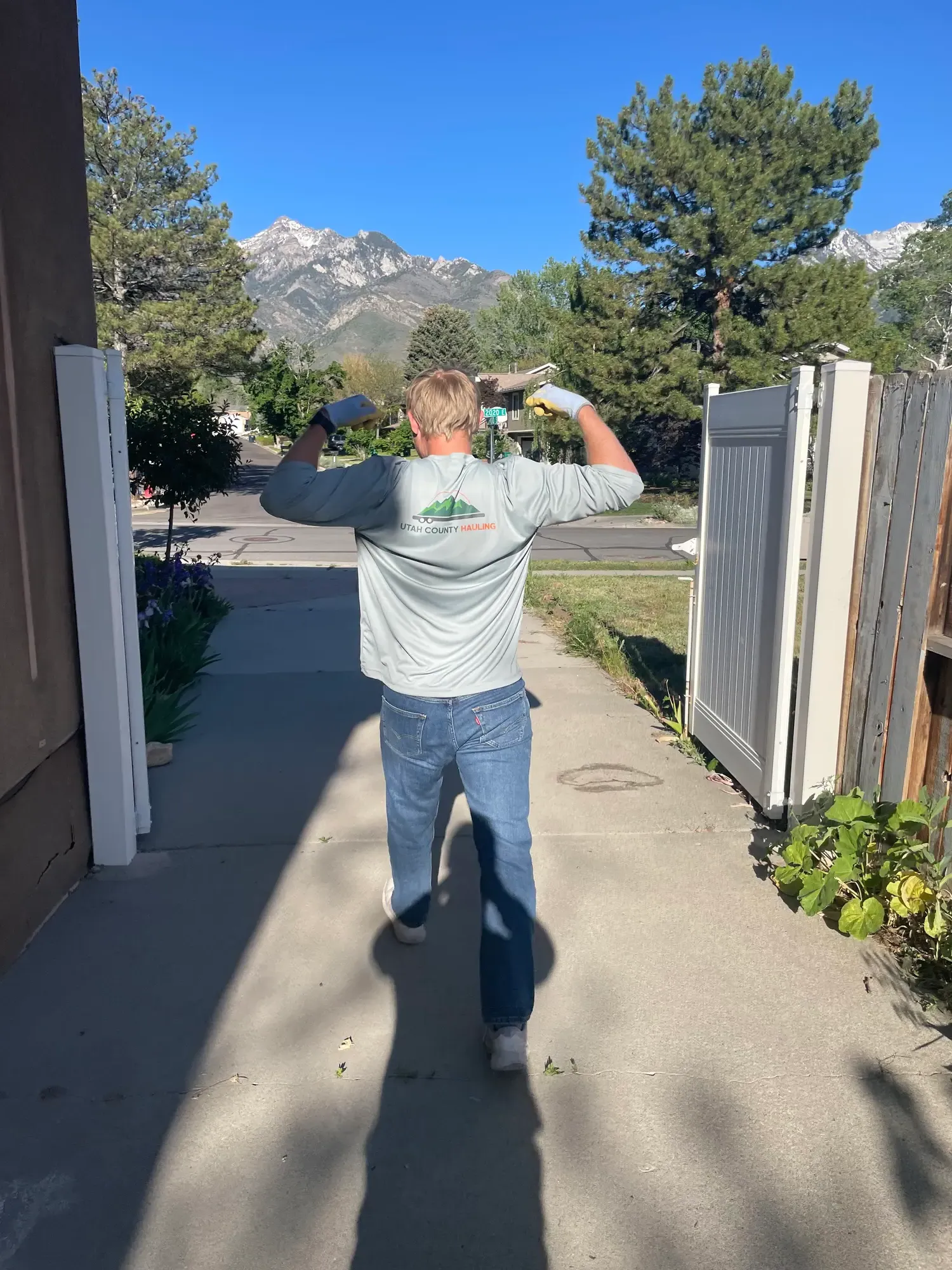 Utah County Hauling team member wearing company shirt outdoors
