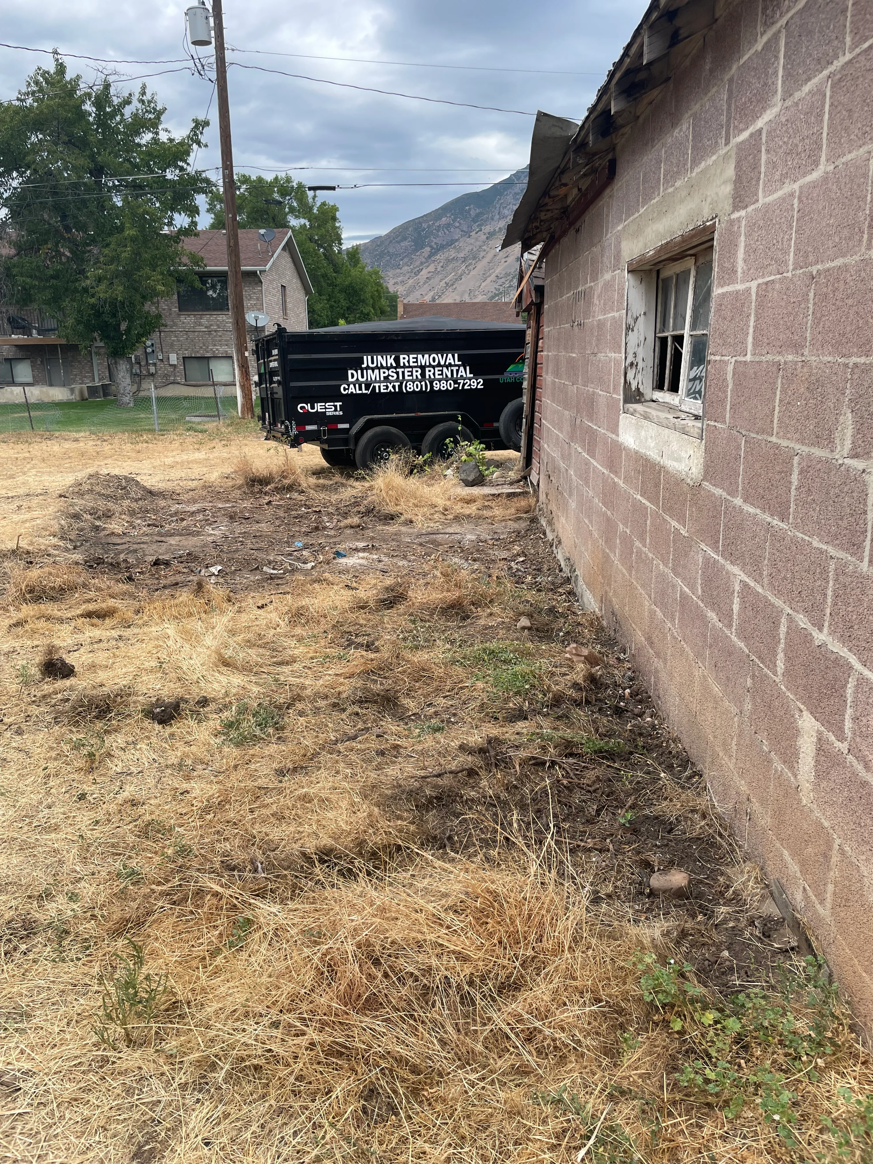 After backyard cleanup showing cleared side yard in Utah County
