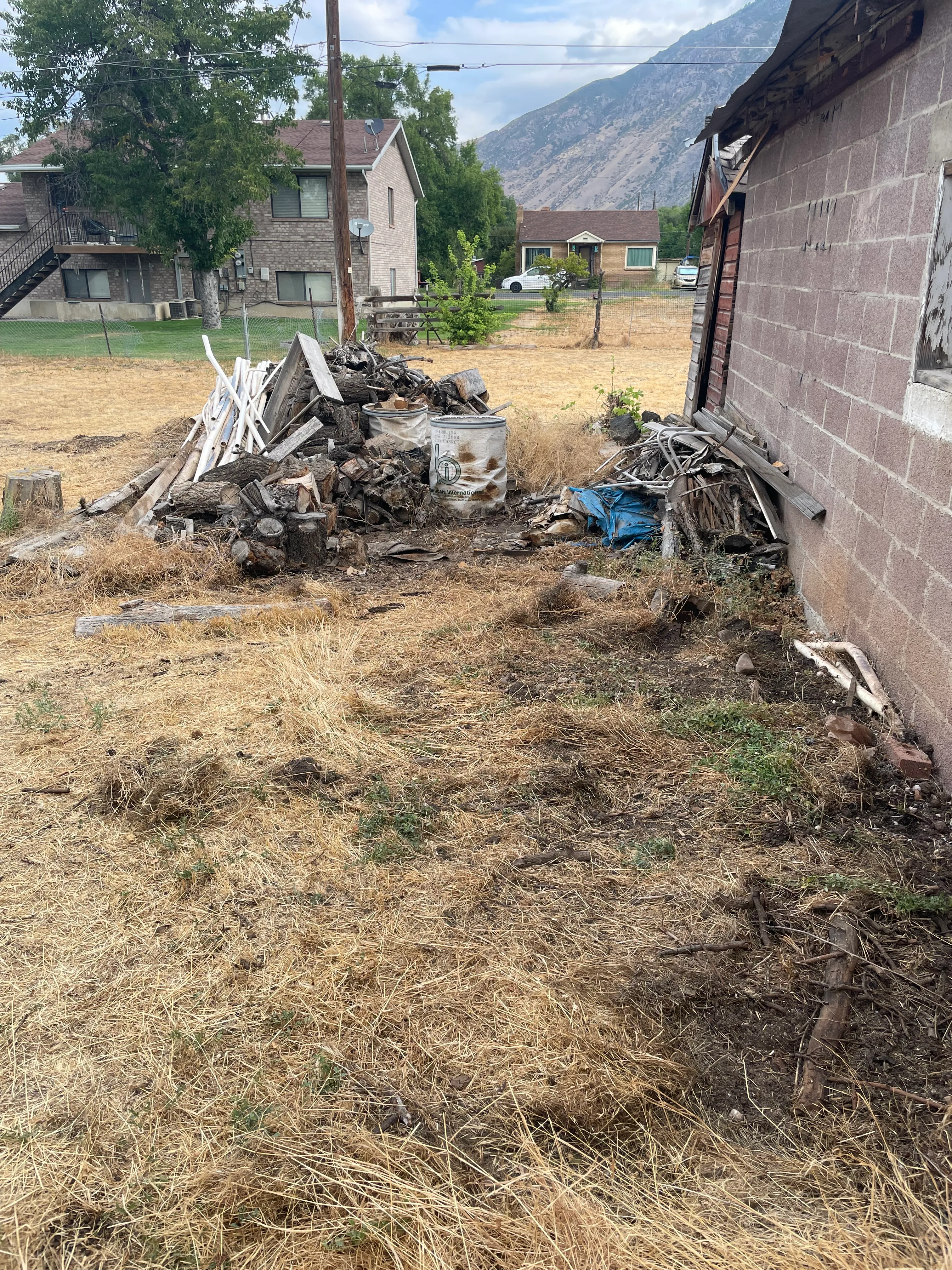 Before backyard view with remaining yard waste and debris in Utah County